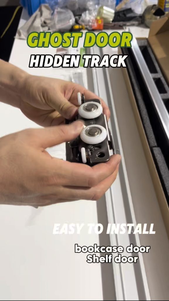 Open the package, and here it is: the ghost door hidden track system. This unboxing takes you through what arrives — the track, the hangers and the fittings, all packed for a clean install. Holding the parts, you can feel the finish and the weight; this is hardware you can trust on site. We are a door hardware manufacturer, and this system is available for OEM. Want to see more of what we make? Please consult us — we are happy to help.